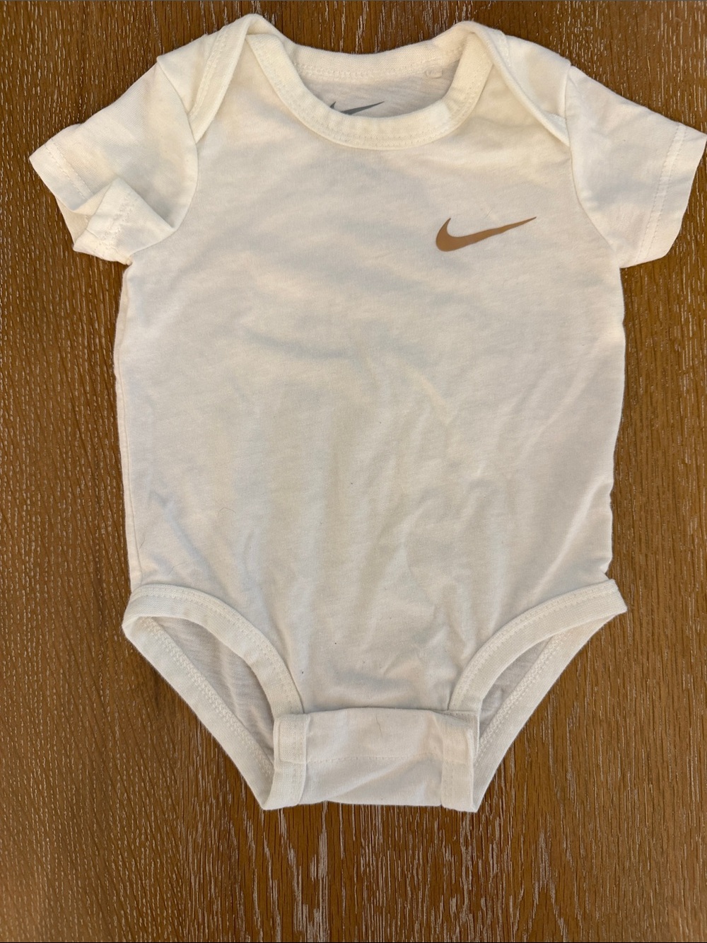 Nike White Baby Bodysuit with Tan Swoosh